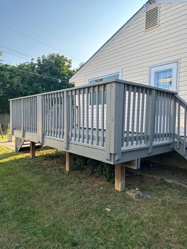 Raised backyard deck with gray painted railings