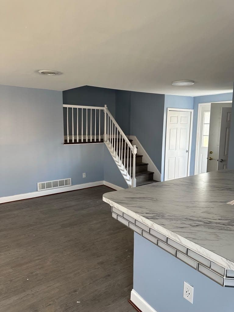 Remodeled kitchen island with marble-look countertop overlooking the living room